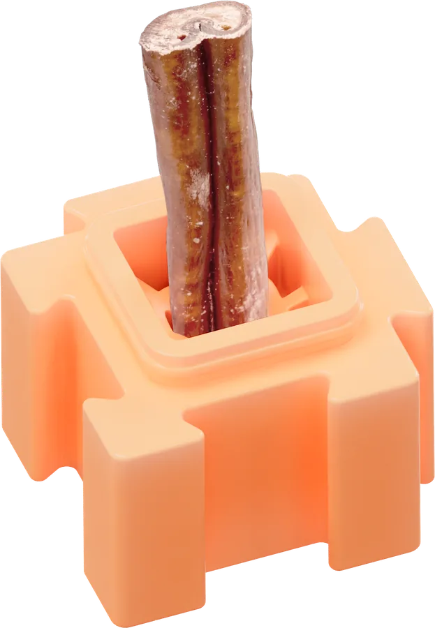 Peach colored HERO LinkBlox holding a bully stick treat upright through its top opening